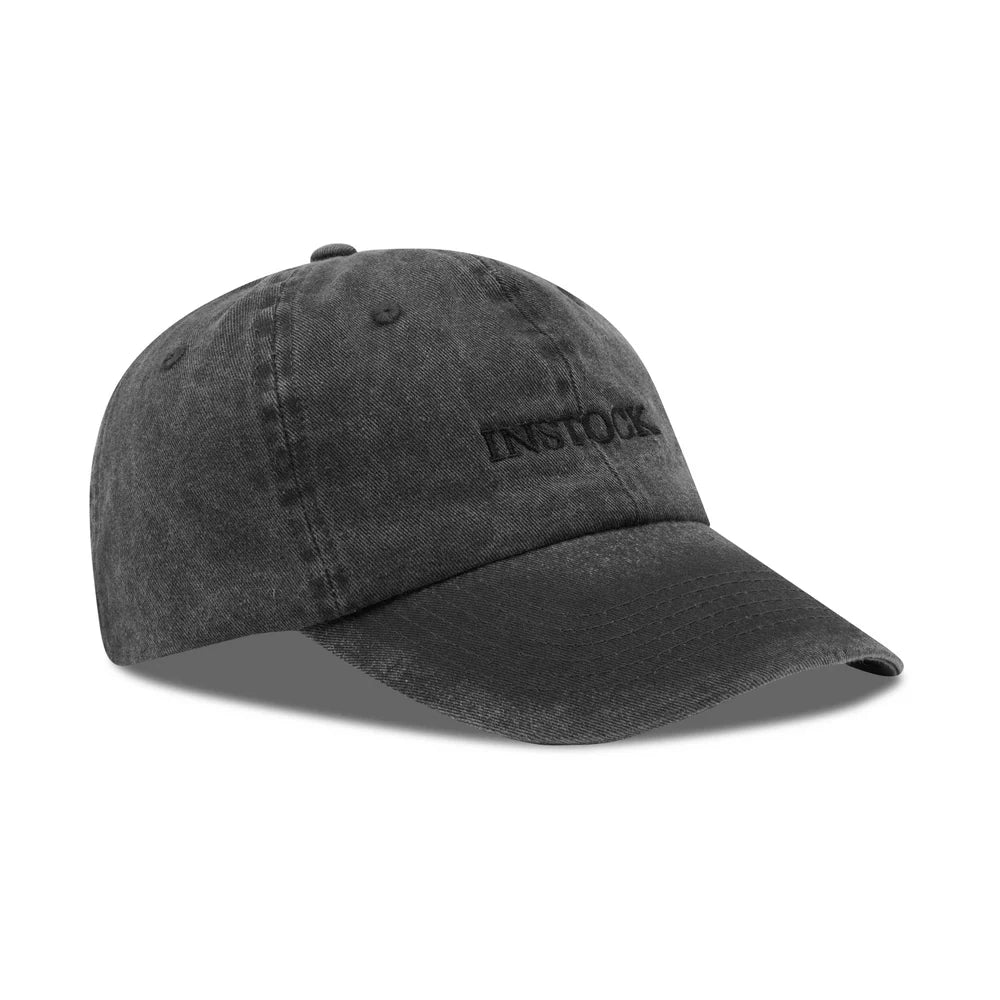 INSTOCK The In Cap in black with black logo, original side-angle product view on white background